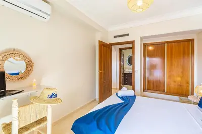 a bedroom with a large bed and a mirror at Chic Majorelle Apartment with Balcony and city view Central & Calm Marrakech in Marrakech