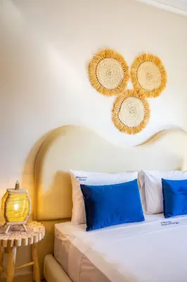 a bedroom with a bed with blue pillows and mirrors on the wall at Chic Majorelle Apartment with Balcony and city view Central & Calm Marrakech in Marrakech