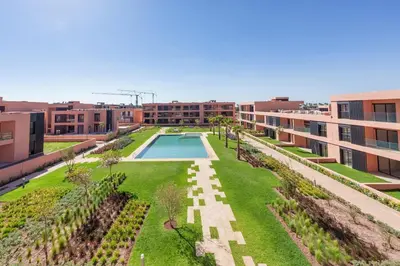 an aerial view of the courtyard of a building with a swimming pool at Amal Cozy - Modern Design, 4 Pools & HD Wifi in Marrakech