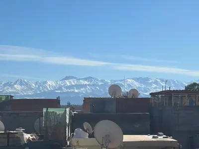 a view of the mountains from a building with satellites at Riad Marhaba in Marrakech