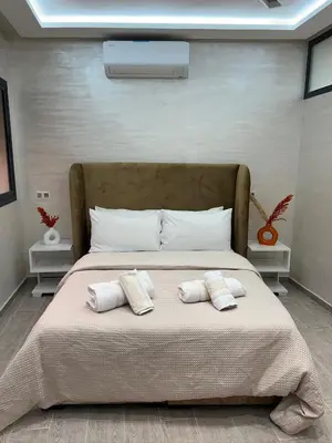 a bedroom with a large bed with two pillows on it at Chic appartement Marrakech in Marrakech