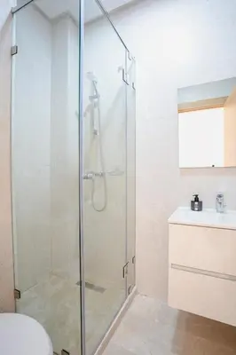 a glass shower in a bathroom with a sink at The Calm Haven - Marrakech - Prestigia in Marrakech