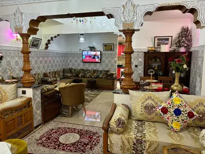 a living room with a couch and a tv at Ryad Karima in Marrakech