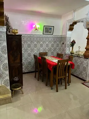 a dining room with a red table and chairs at Ryad Karima in Marrakech