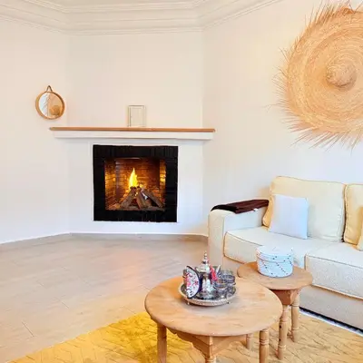 a living room with a couch and a fireplace at Meriso Downtown Free Parking in Marrakech