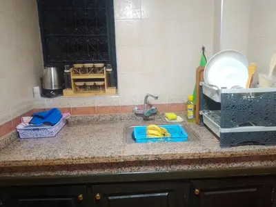 a kitchen counter with a sink and a mirror at House of Diamonds in Marrakech
