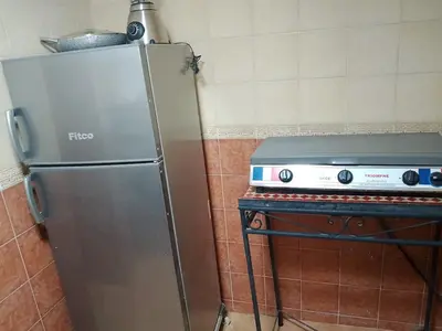 a stainless steel refrigerator next to a stove in a kitchen at House of Diamonds in Marrakech
