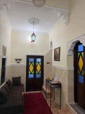 a living room with a couch and a stained glass door at House of Diamonds in Marrakech