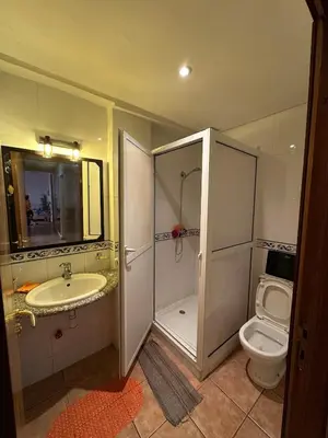 a bathroom with a toilet and a sink and a shower at Appartement Marrakech Gueliz in Marrakech