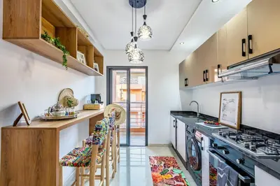 a kitchen with a stove and a counter with stools at Guéliz I Blue Mirage I Crafts and modernity in Marrakech