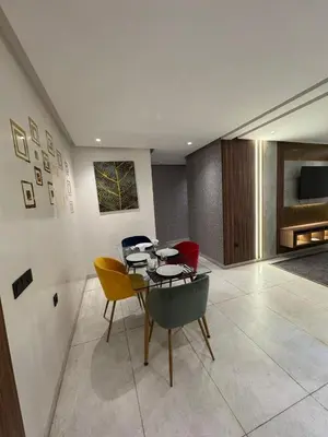 a dining room with a table and some chairs at Stylish 2-Bed Retreat in Marrakech Free Parking in Marrakech