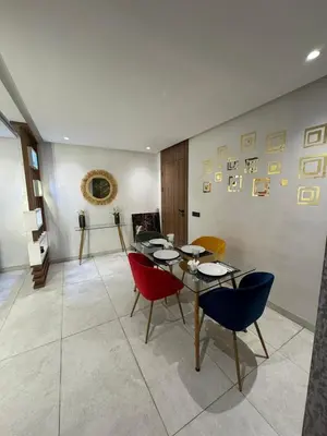 a dining room with a table and chairs at Stylish 2-Bed Retreat in Marrakech Free Parking in Marrakech