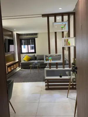 a living room with a couch and a table at Stylish 2-Bed Retreat in Marrakech Free Parking in Marrakech