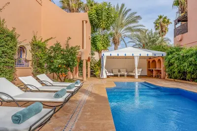 a pool with lounge chairs and a gazebo at Villa Chahrazad - 8prs - Piscine - Wifi in Marrakech