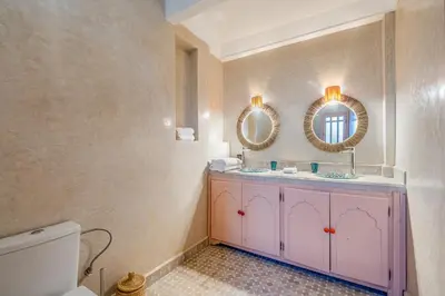 a bathroom with a pink vanity and two mirrors at Villa Chahrazad - 8prs - Piscine - Wifi in Marrakech