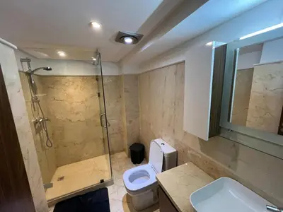a bathroom with a shower and a toilet and a sink at Elegant duplex Marrakech in Marrakech