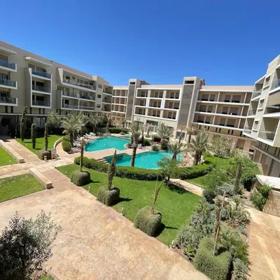 an apartment complex with a courtyard with a swimming pool at Modern apartment with pool view, Kech in Marrakech