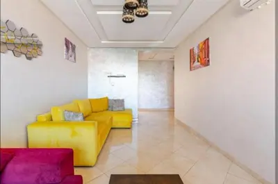 a living room with a yellow couch in a room at appartement 2 chabres marrakech in Marrakech