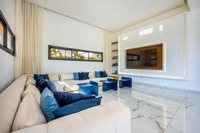 a living room with a couch and a tv at Palais Mahora in Marrakech