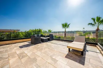 a patio with chairs and a view of the ocean at Palais Mahora in Marrakech