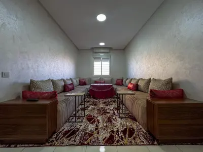 a living room with a large couch in a room at Apartment in Marrakech near McDonald's Massira in Marrakech