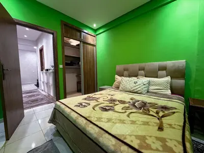 a green bedroom with a bed with a green wall at Apartment in Marrakech near McDonald's Massira in Marrakech