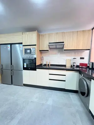 a large kitchen with a refrigerator and a dishwasher at MayyRakech in Marrakech