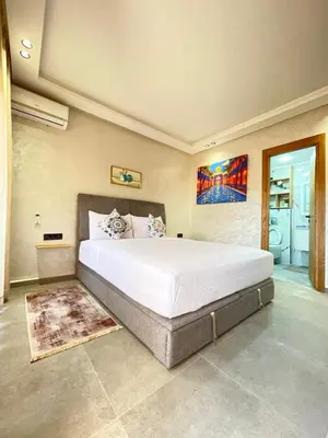 a bedroom with a large white bed in a room at MayyRakech in Marrakech