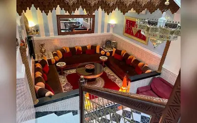 a living room with a couch and a table at Riad Marrakech Red Ruby in Marrakech