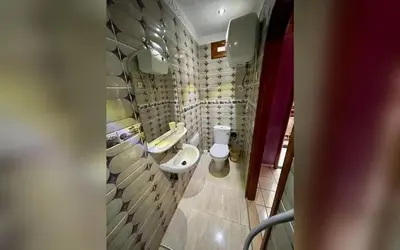 a bathroom with two toilets and a sink at Riad Marrakech Red Ruby in Marrakech