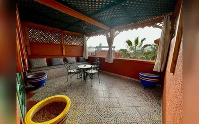 a room with a table and chairs and a window at Riad Marrakech Red Ruby in Marrakech
