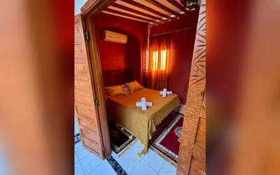 a bedroom with a bed in a red room at Riad Marrakech Red Ruby in Marrakech