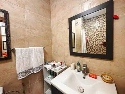 a bathroom with a sink and a mirror at Le Nid de l'Hivernage - Piscine et Confort Moderne in Marrakech