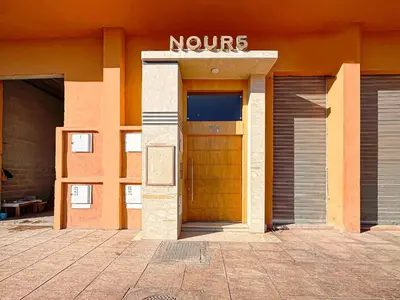 a entrance to a building with a yellow door at Le Nid de l'Hivernage - Piscine et Confort Moderne in Marrakech