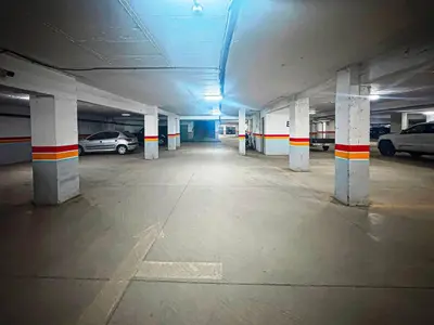 an empty parking garage with cars parked in it at Le Nid de l'Hivernage - Piscine et Confort Moderne in Marrakech