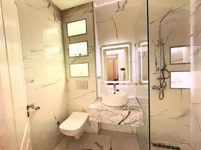 a white bathroom with a sink and a toilet at Appartement Cosy and Calme Proche Centre Marrakech in Marrakech