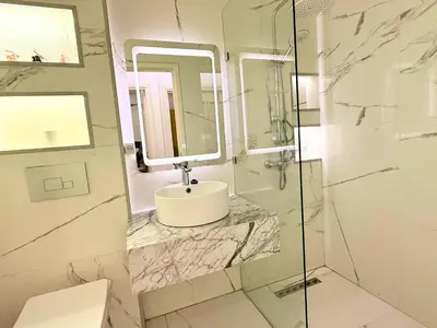 a bathroom with a marble sink and a shower at Appartement Cosy and Calme Proche Centre Marrakech in Marrakech