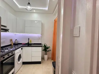 a kitchen with a sink and a stove top oven at Appartement Cosy and Calme Proche Centre Marrakech in Marrakech
