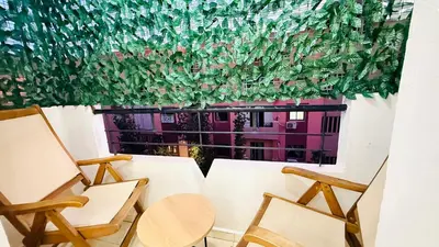 a room with a table and chairs and a window at Appartement Cosy and Calme Proche Centre Marrakech in Marrakech