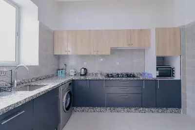a kitchen with blue cabinets and a sink at Maison du Pacha in Marrakech