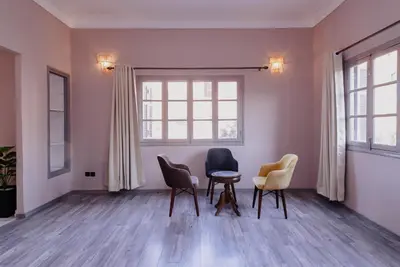 a room with chairs and a table and a window at Maison du Pacha in Marrakech