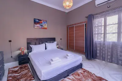 a bedroom with a large white bed and a window at Maison du Pacha in Marrakech
