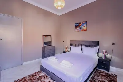 a bedroom with a large white bed with two towels on it at Maison du Pacha in Marrakech