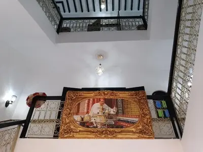 a framed picture of a priest in a room at Riad Alhana in Marrakech