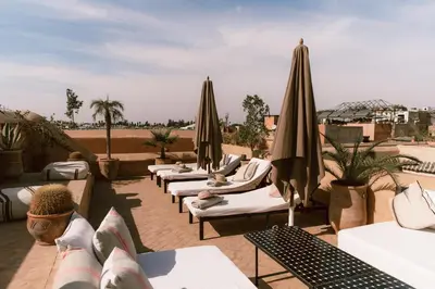 a row of chairs and umbrellas on a patio at Riad K in Marrakech