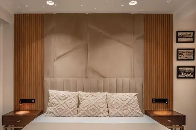a bed with a large padded headboard in a bedroom at Luxury 3 bedroom with private pool and spa in Marrakech