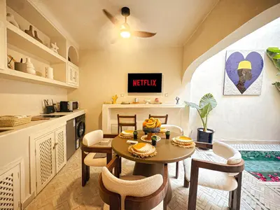 a kitchen and dining room with a table and chairs at Riad Medina Luxury Charm in Marrakech