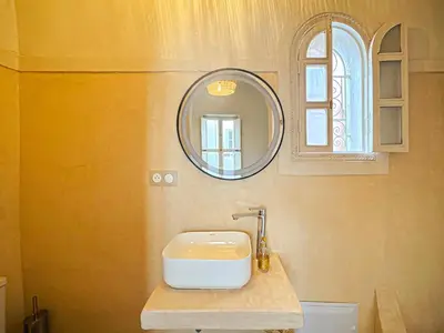 a bathroom with a sink and a mirror at Riad Medina Luxury Charm in Marrakech