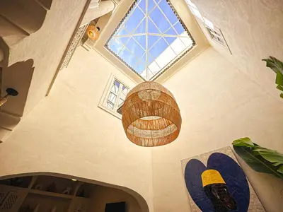 a ceiling with a large window and a chandelier at Riad Medina Luxury Charm in Marrakech