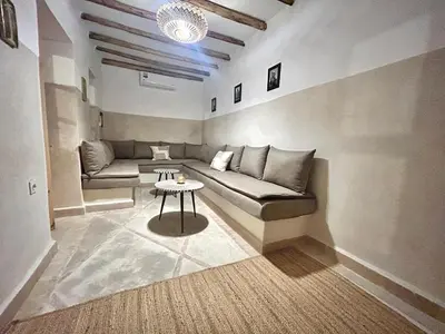 a living room with a couch and a table at Welcome to Riad Mariam & Maïwenn! in Marrakech